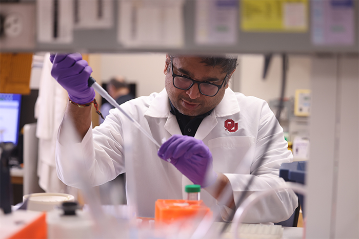 Cell Biology researchers examining microscopy images of primary cilia in a laboratory